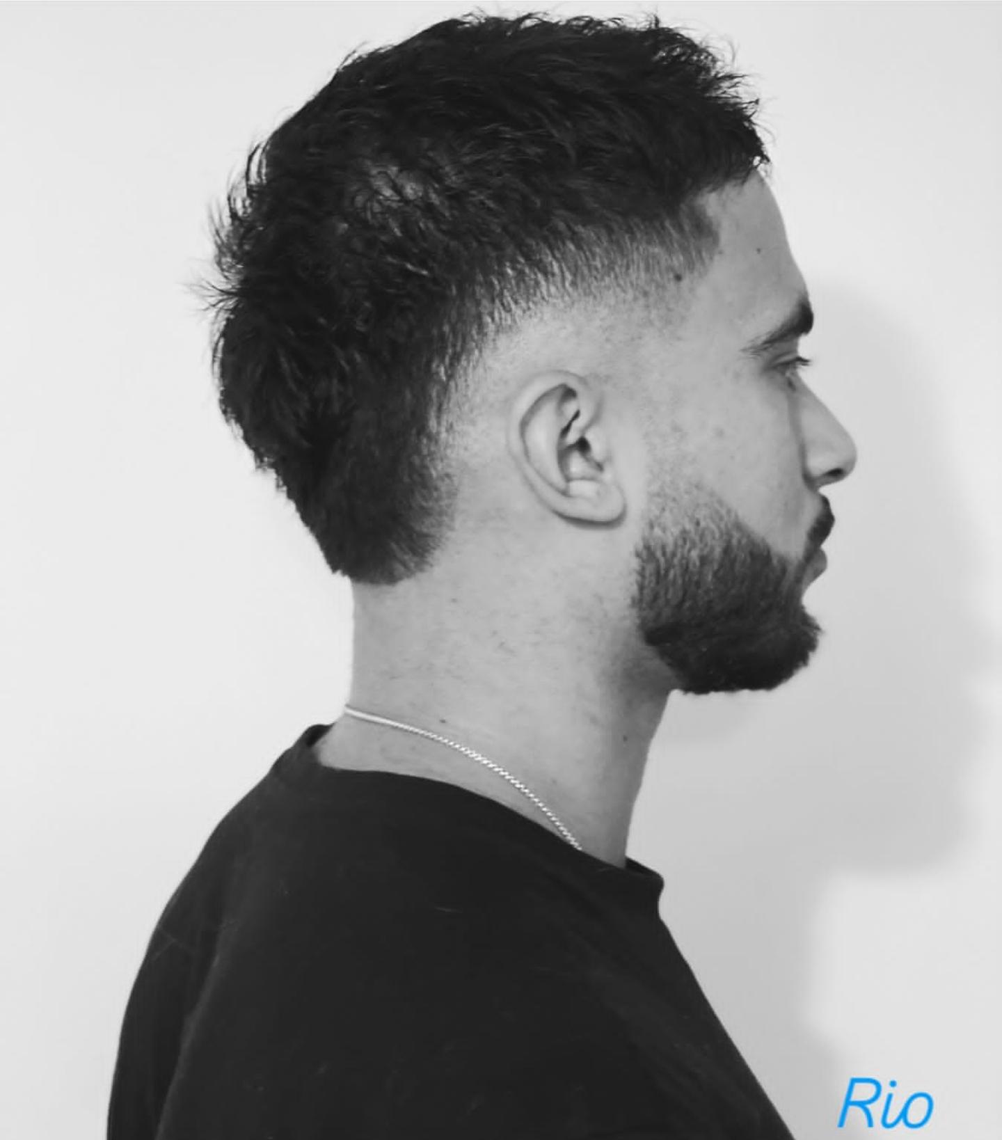 Sharp side-part skin fade with sculpted beard